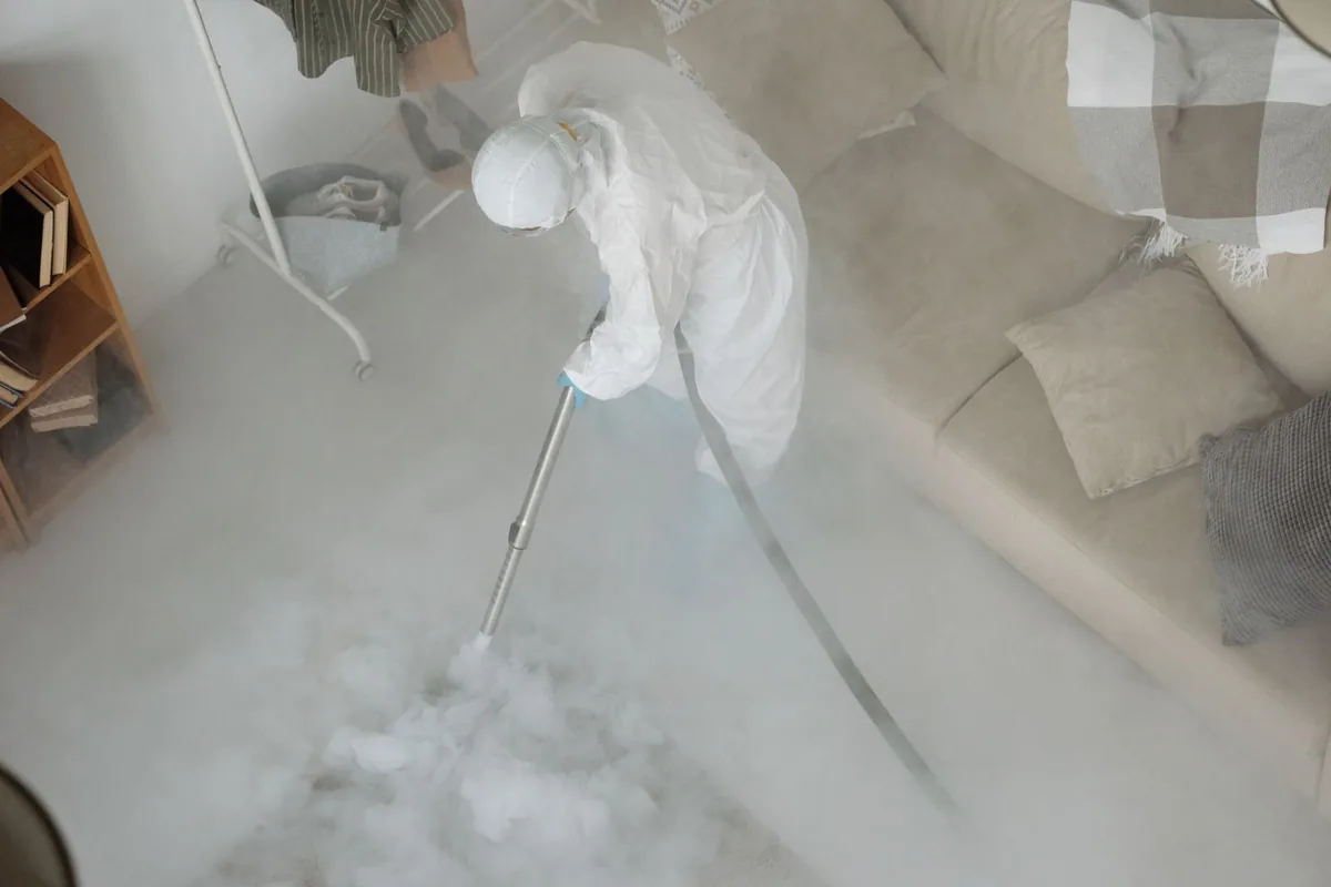 Biohazard cleanup technician in protective equipment, Hilltop Lakes, TX